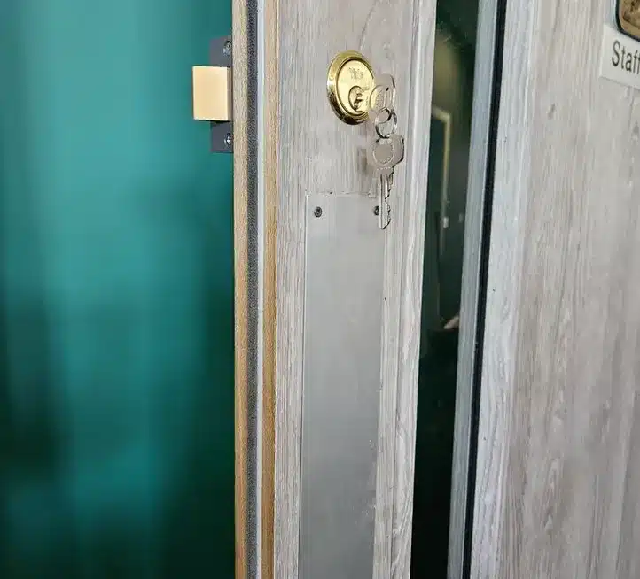 Installed Night latch box on a door and lock with a key on it