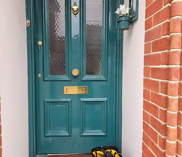 Nice dark green Victorian door with brass elements and lock